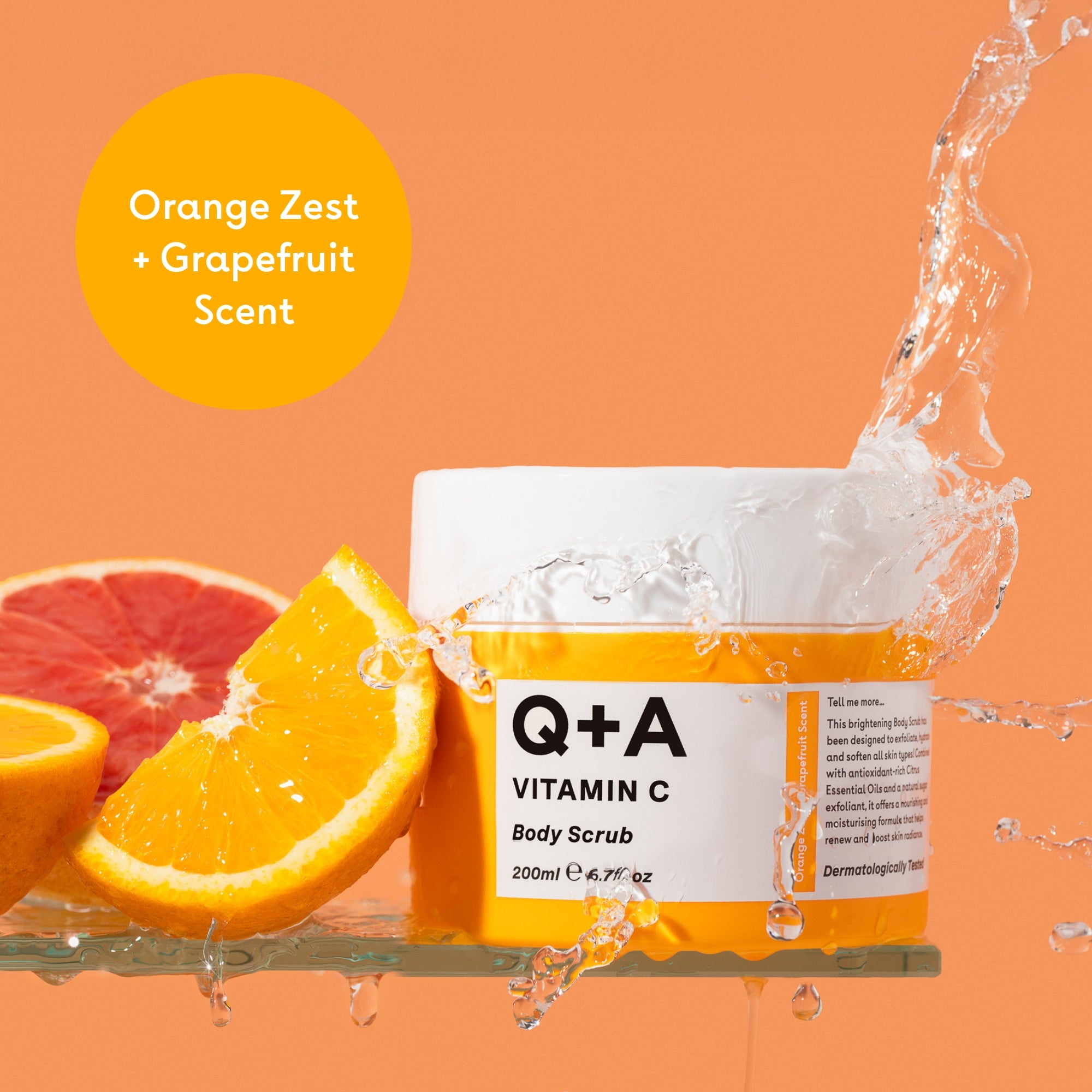 Q+A Vitamin C Body Scrub with oranges and grapefruit on an orange background